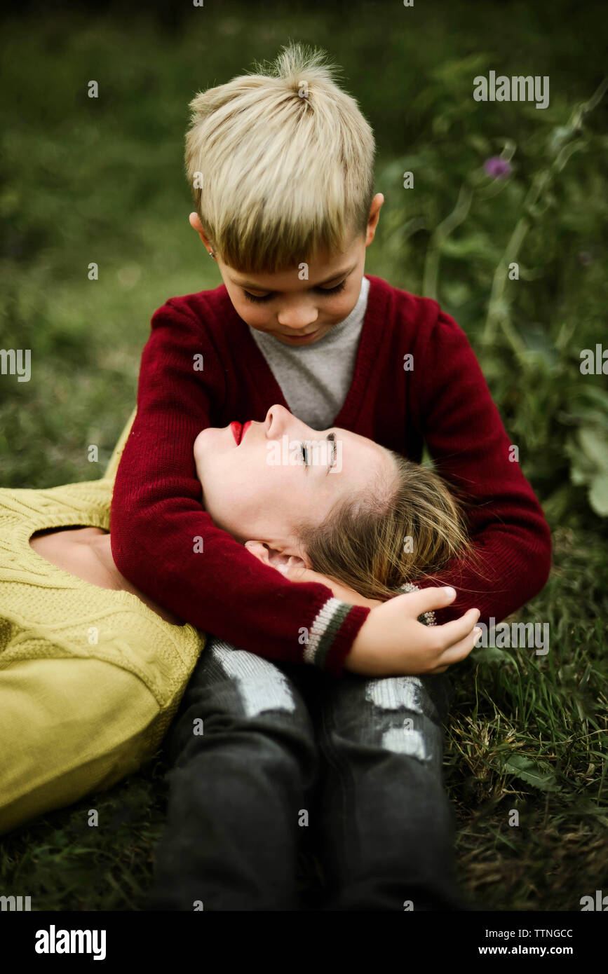 Son embracing mother on field in the countryside Stock Photo