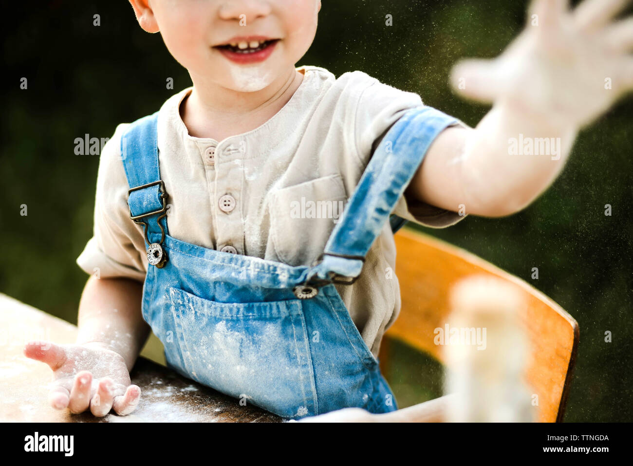 Portrait of boy preparing food in yard Stock Photo