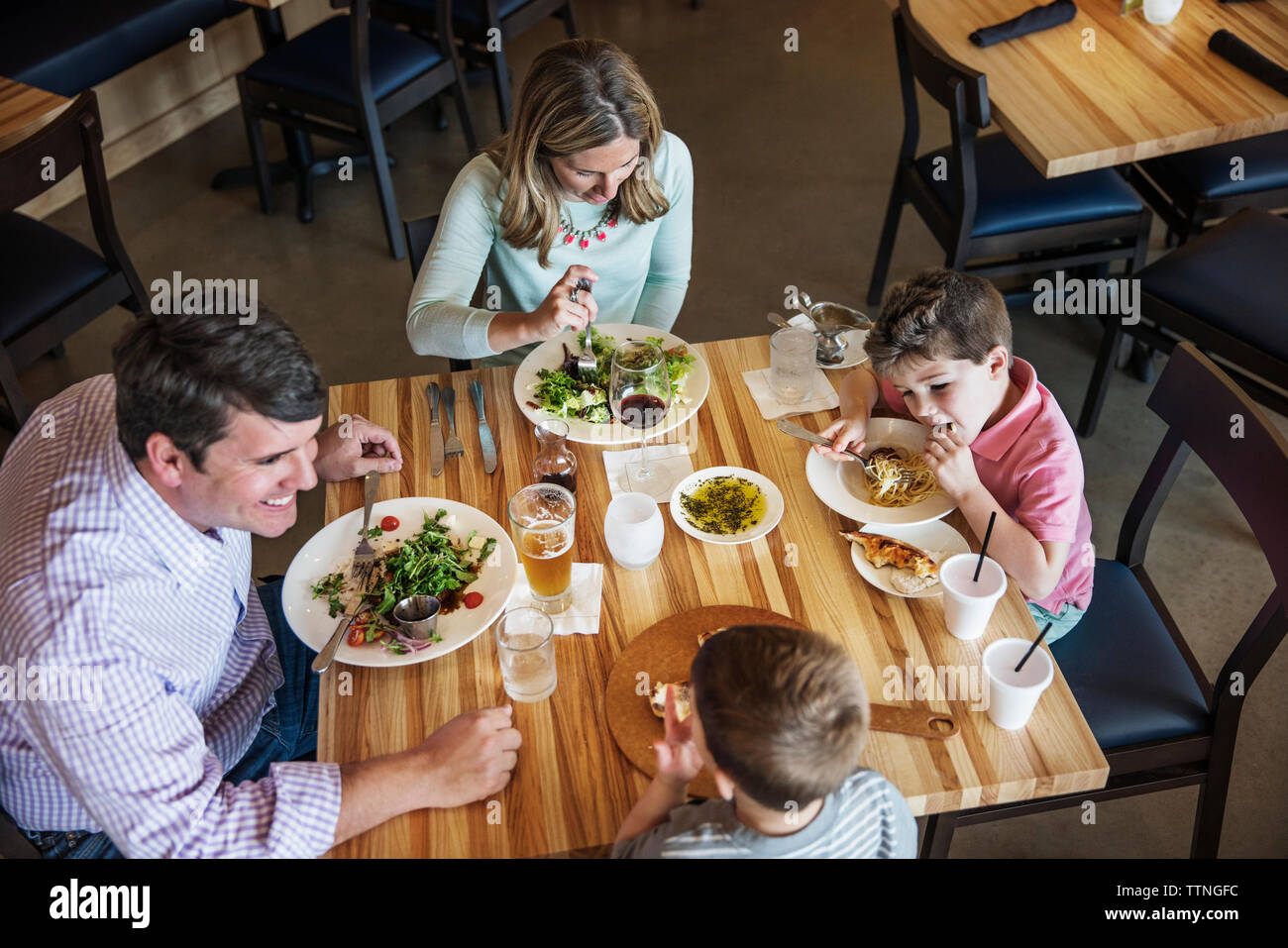 Overhead view of family eating food in restaurant Stock Photo