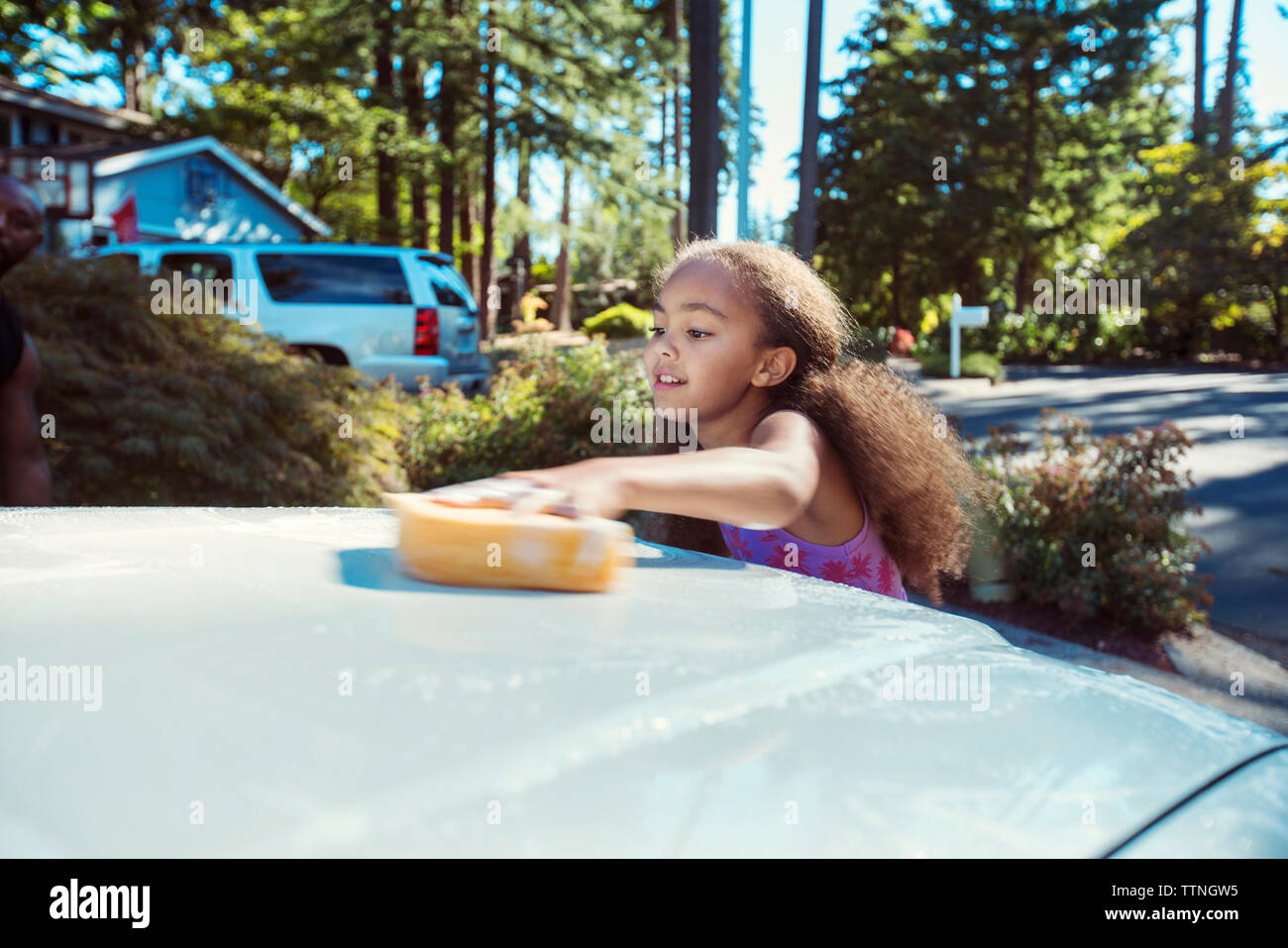 Girl washing car in driveway Stock Photo Alamy