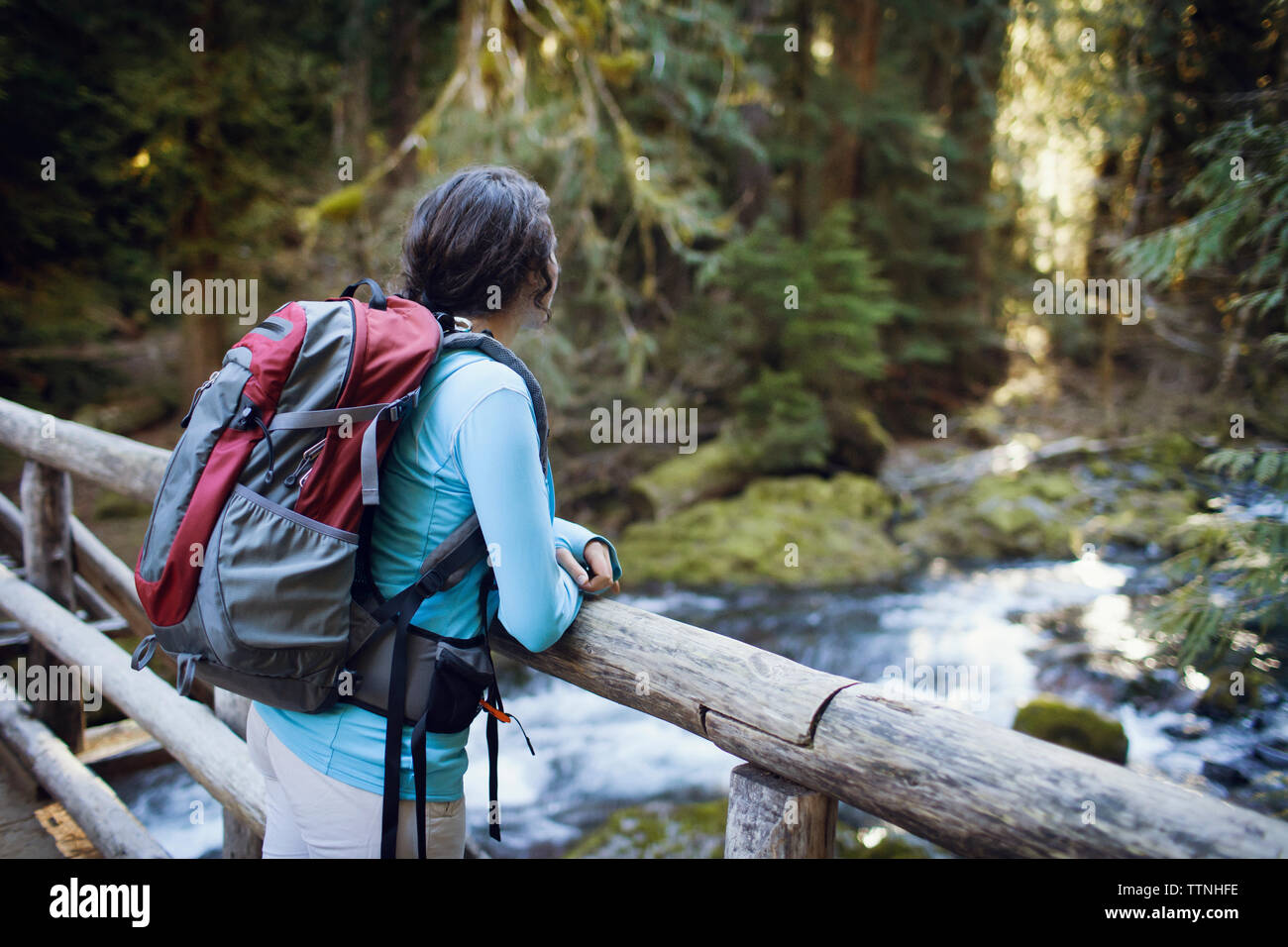 Young woman leaning on wooden bridge Stock Photo