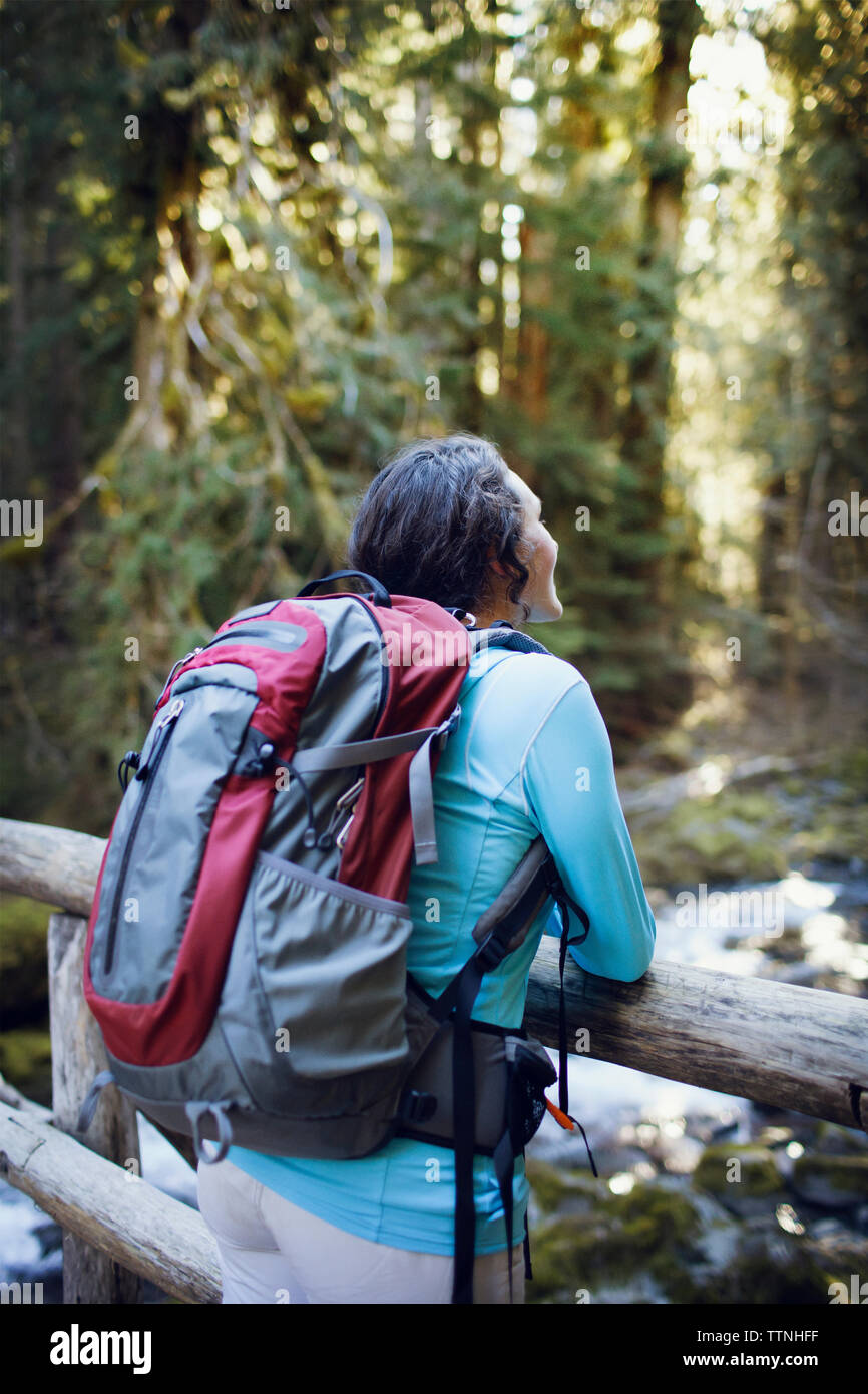 Young woman leaning on wooden bridge Stock Photo