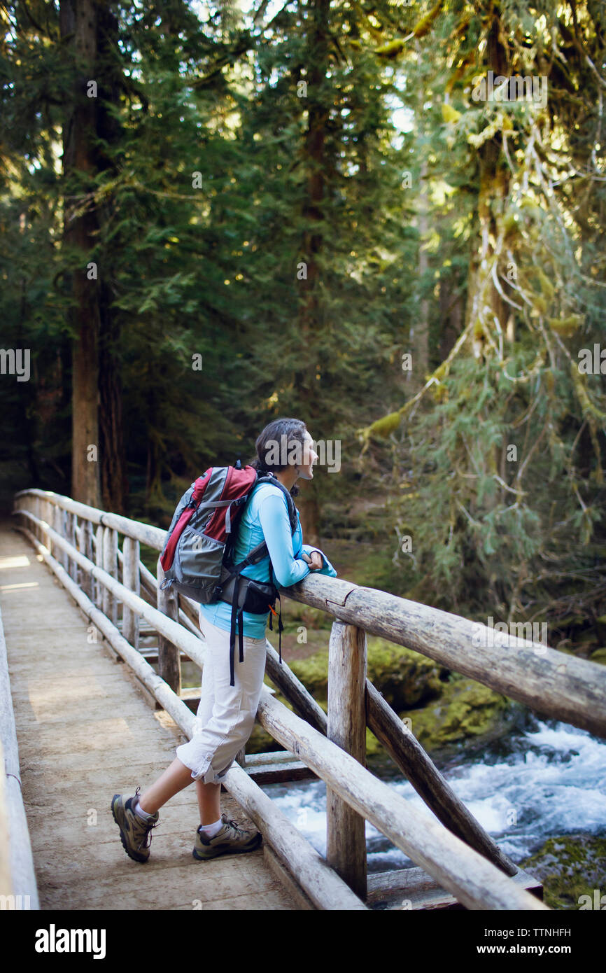 Young woman leaning on wooden bridge Stock Photo