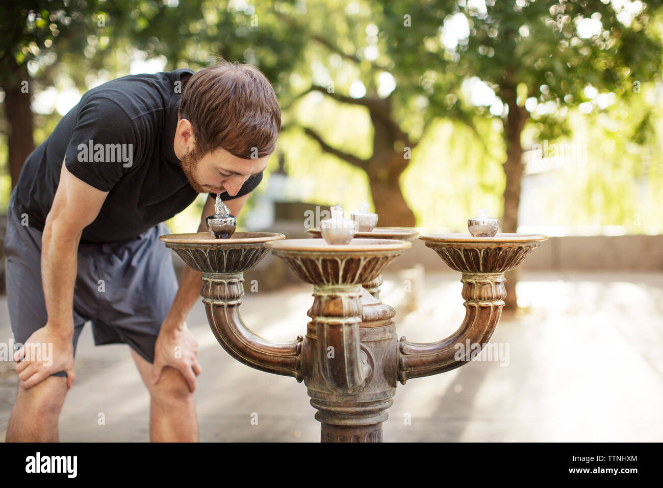 Man drinking water from fountain Stock Photo Alamy