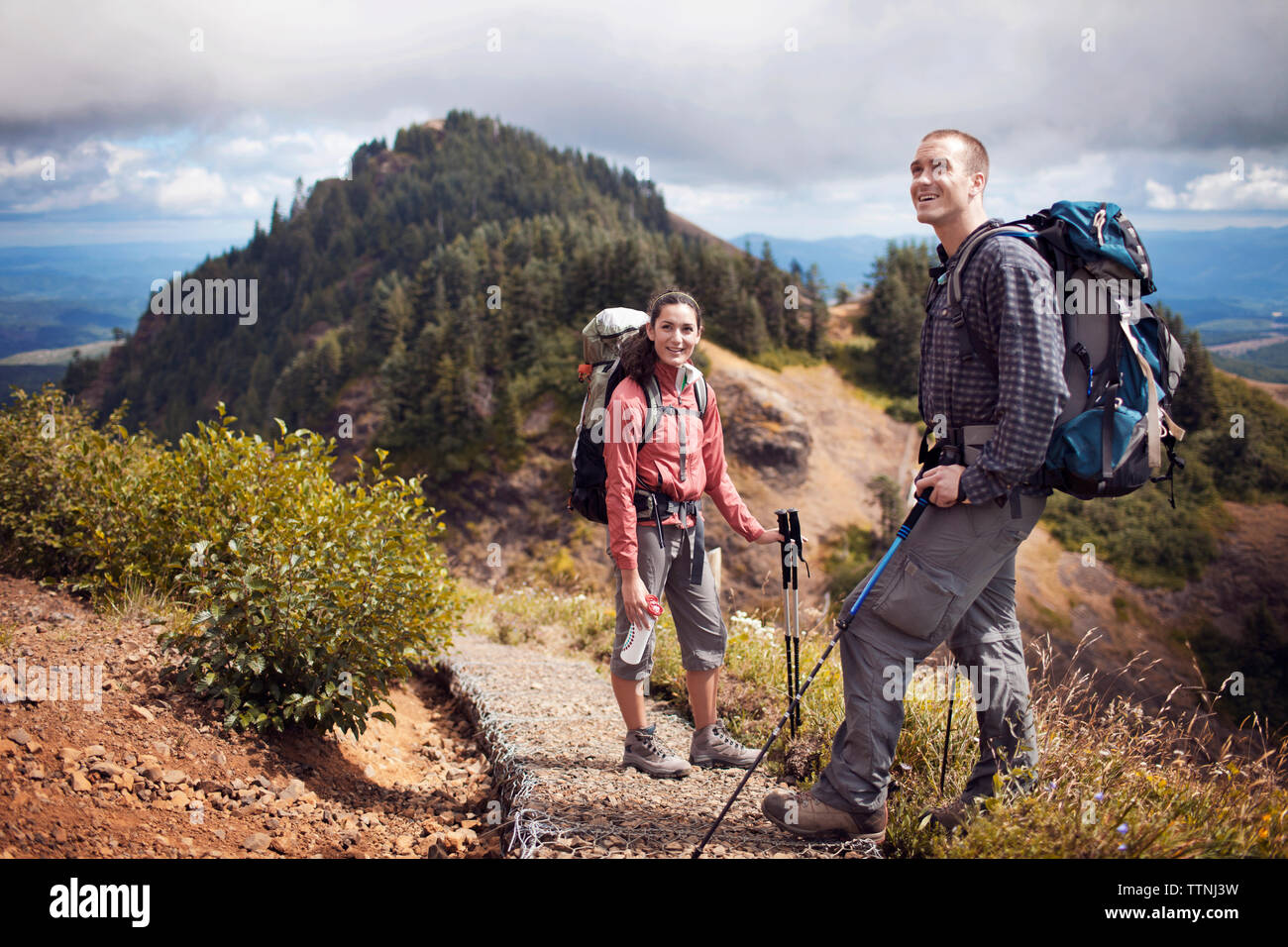 Happy man woman hiking mountains hi-res stock photography and images ...