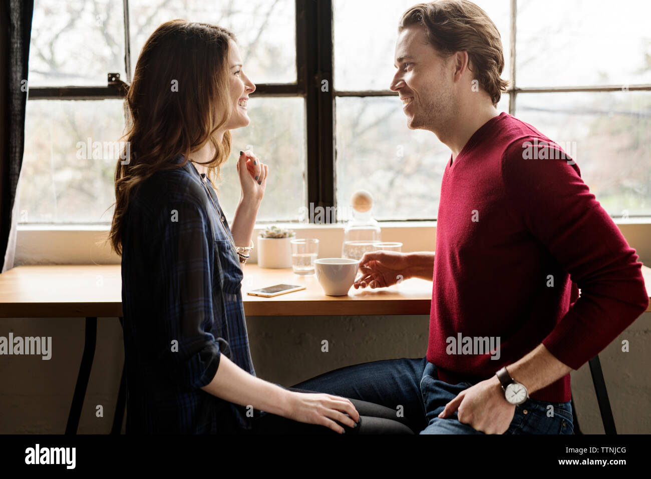 Happy couple looking face to face in cafe Stock Photo