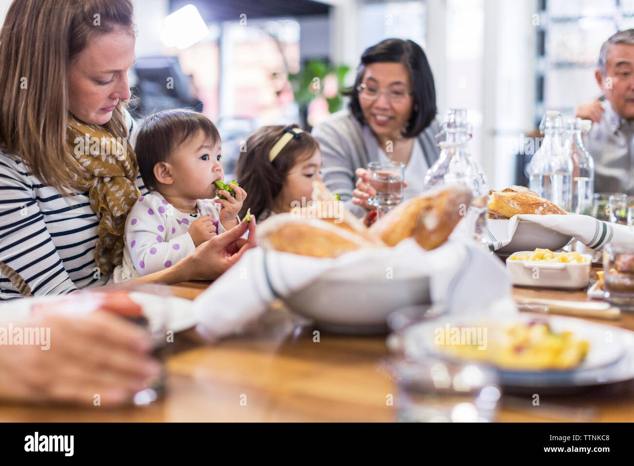 Family eating food in restaurant Stock Photo