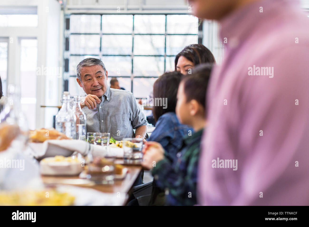 Family enjoying lunch in restaurant Stock Photo