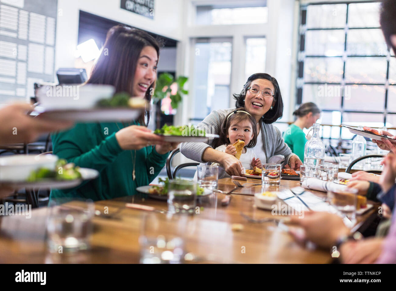 Happy family having lunch in restaurant Stock Photo