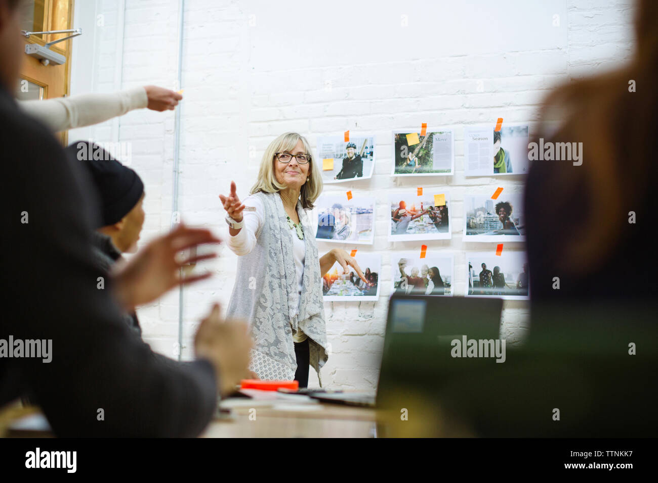 Senior businesswoman discussing with colleagues in meeting at board room Stock Photo