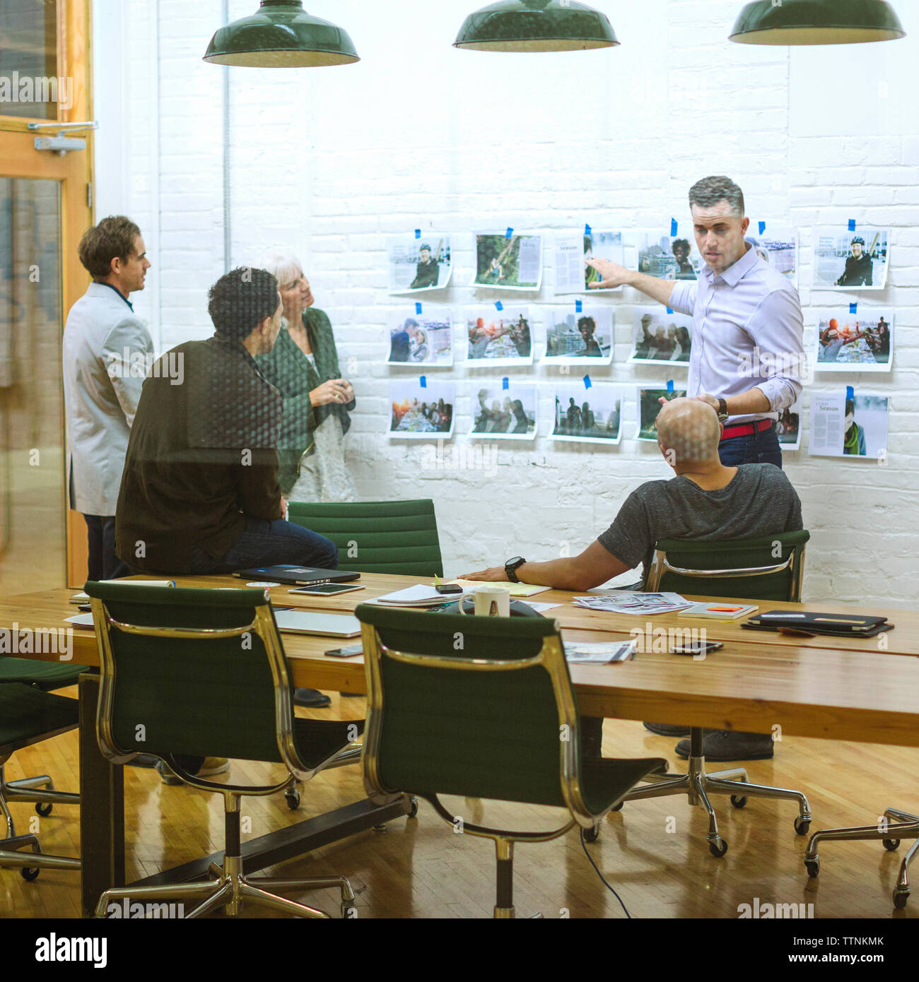 business people discussing in meeting at board room seen through glass Stock Photo