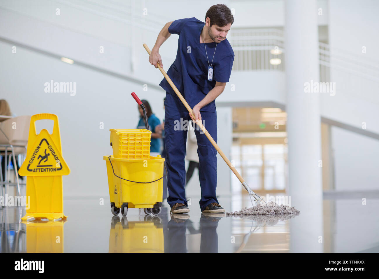 Male worker cleaning hospital floor Stock Photo