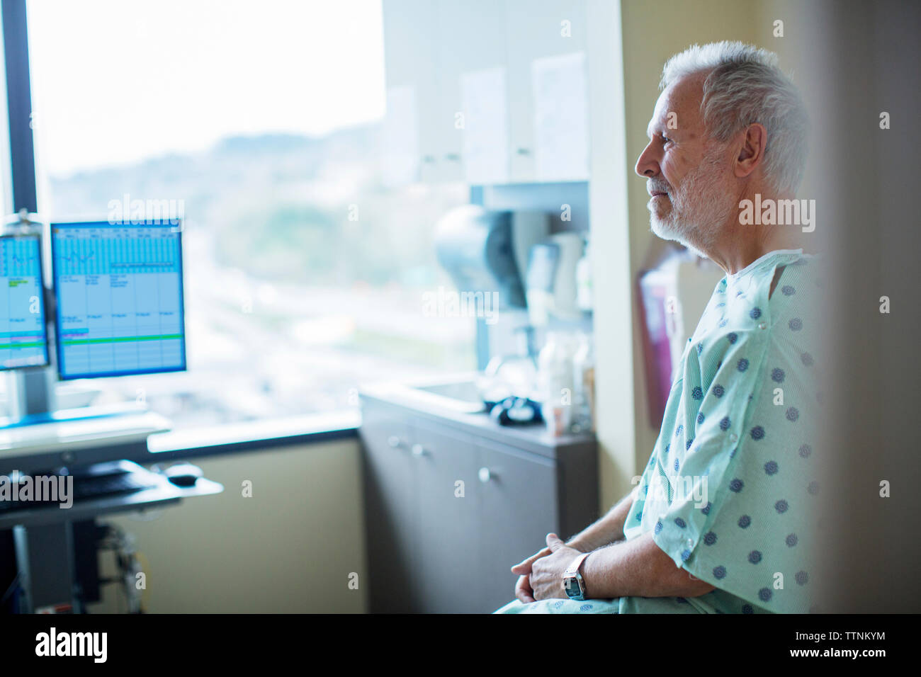 Patient looking away while relaxing in hospital ward Stock Photo