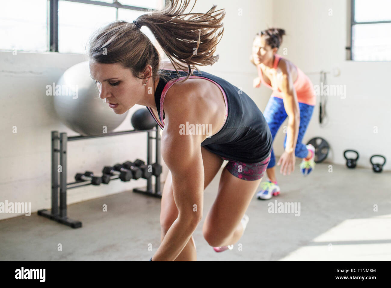 Female athletes running in gym Stock Photo