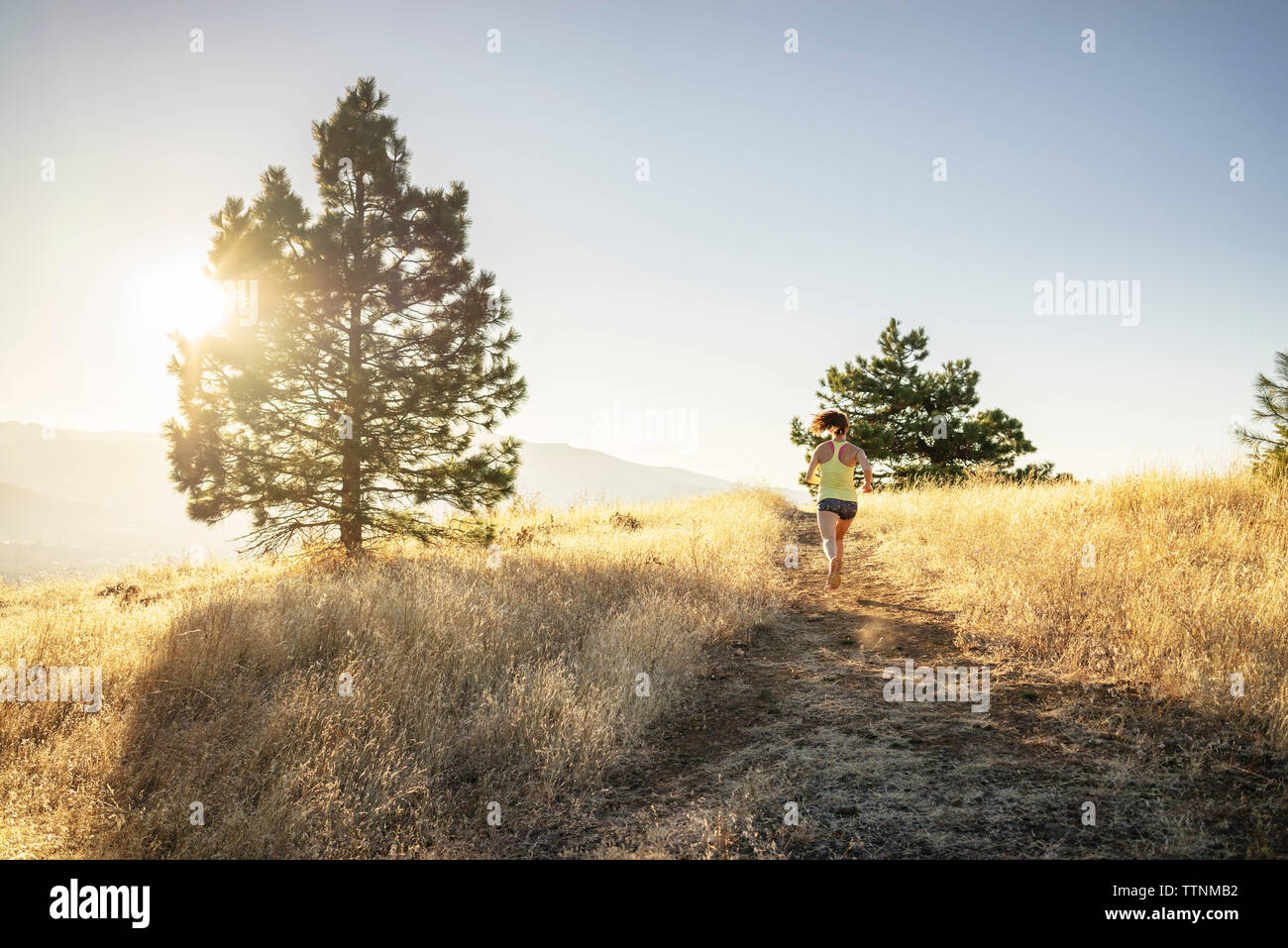 Rear view jogging woman hi-res stock photography and images - Alamy