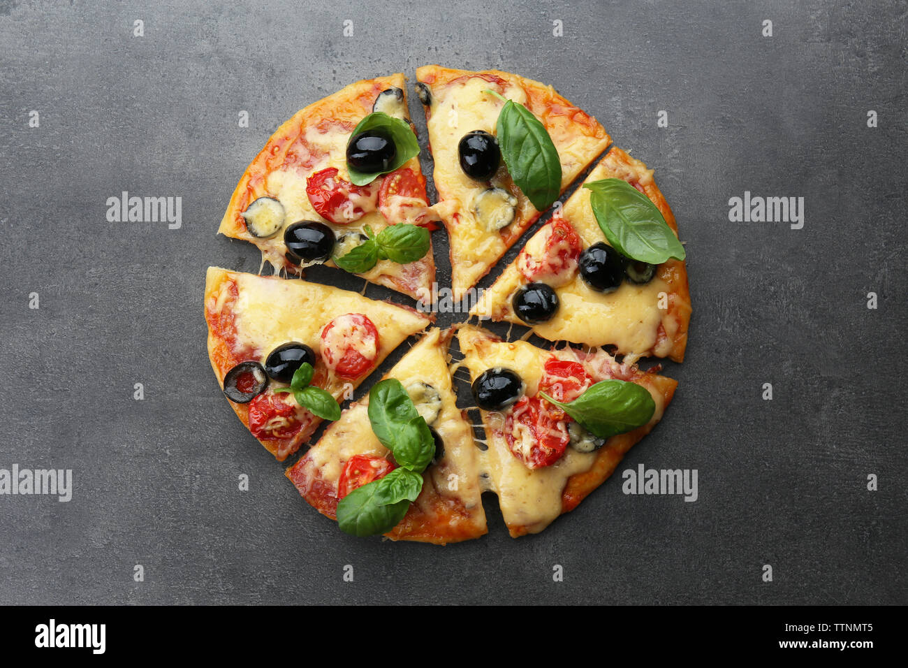 Sliced delicious pizza on gray background Stock Photo - Alamy