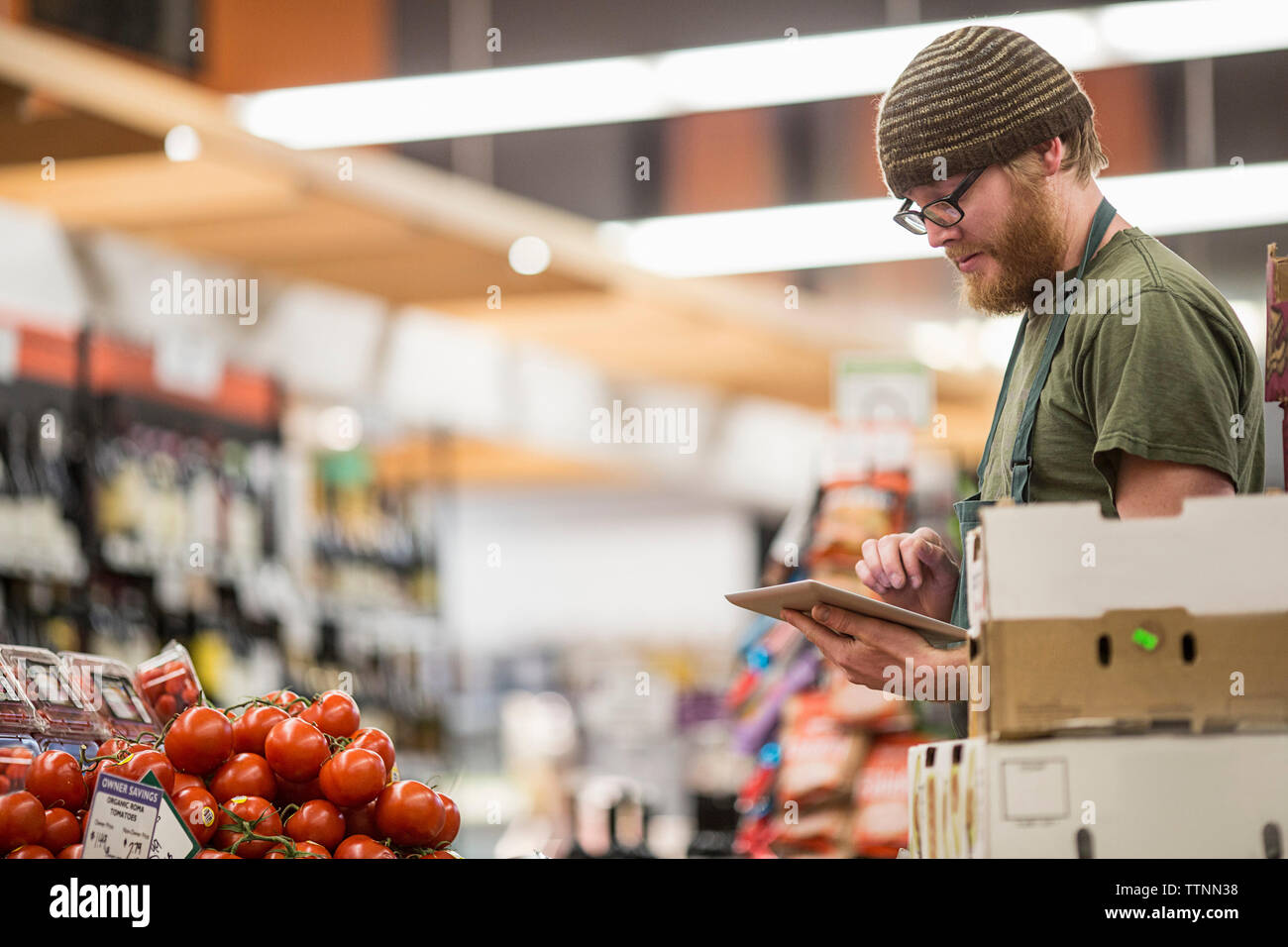 worker using tablet computer at supermarket Stock Photo