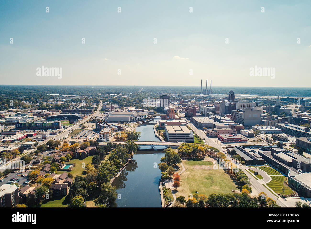 Aerial view of cityscape against sky during sunny day Stock Photo