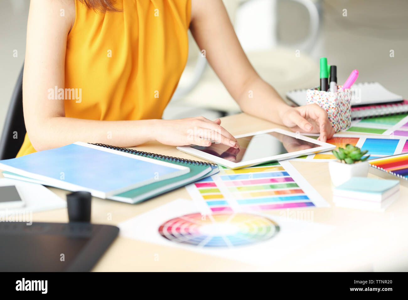 Designer workplace. Woman using tablet Stock Photo