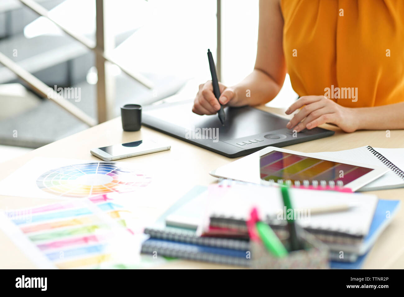 Designer workplace. Woman using tablet Stock Photo