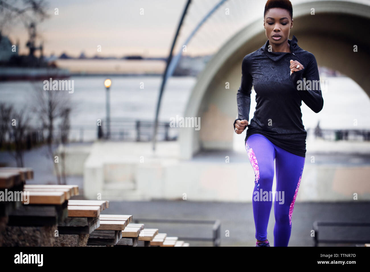 Determined female athlete running at stadium Stock Photo