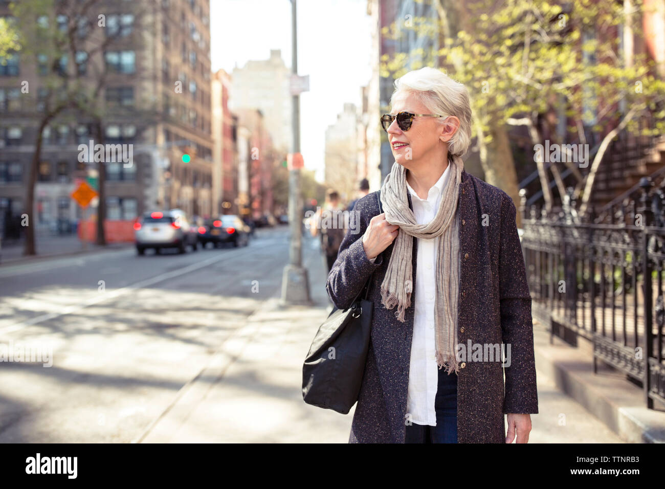 Woman standing on the street hi-res stock photography and images - Alamy