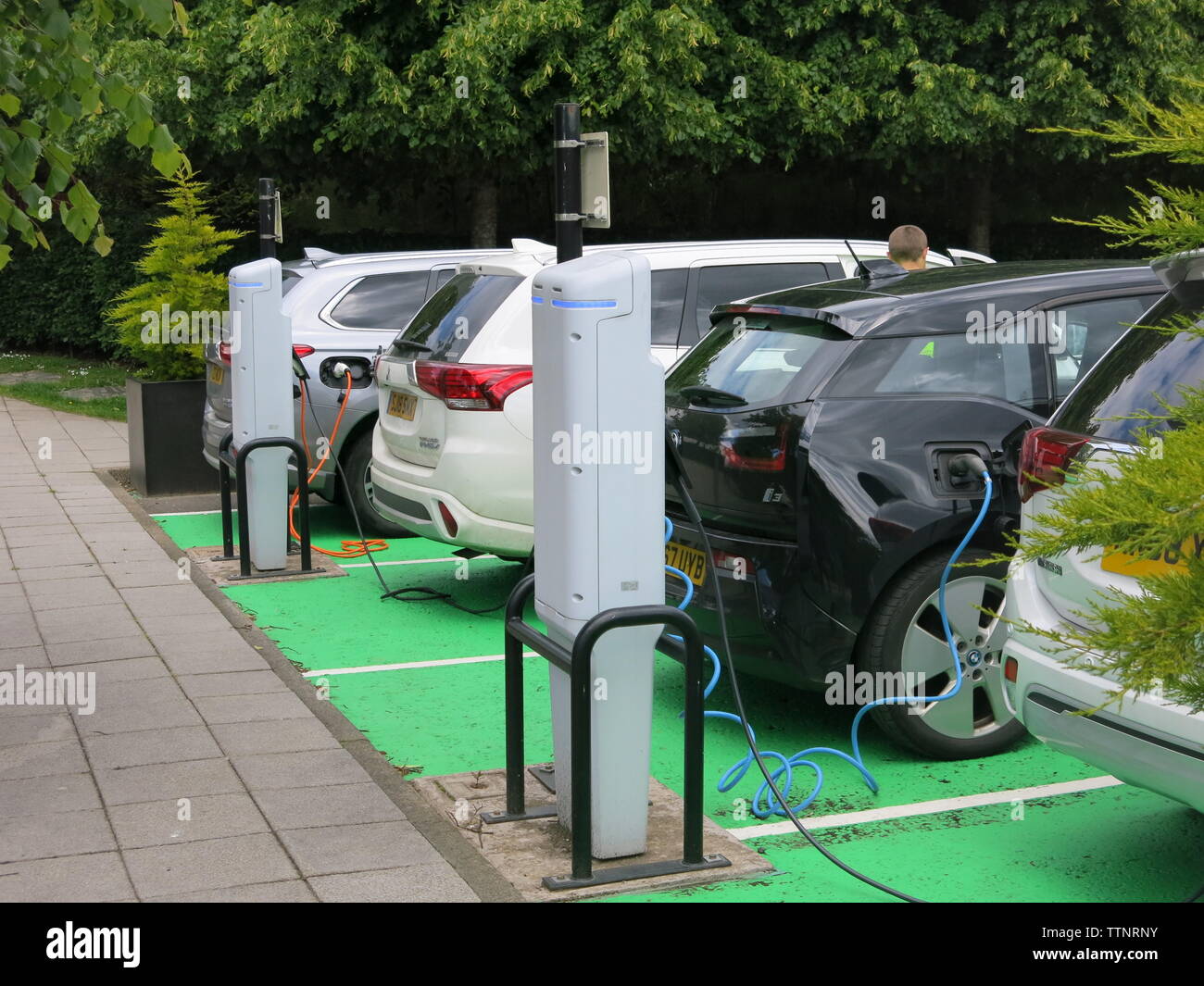 Photo of four cars at an electric car chargingpoint, where they have