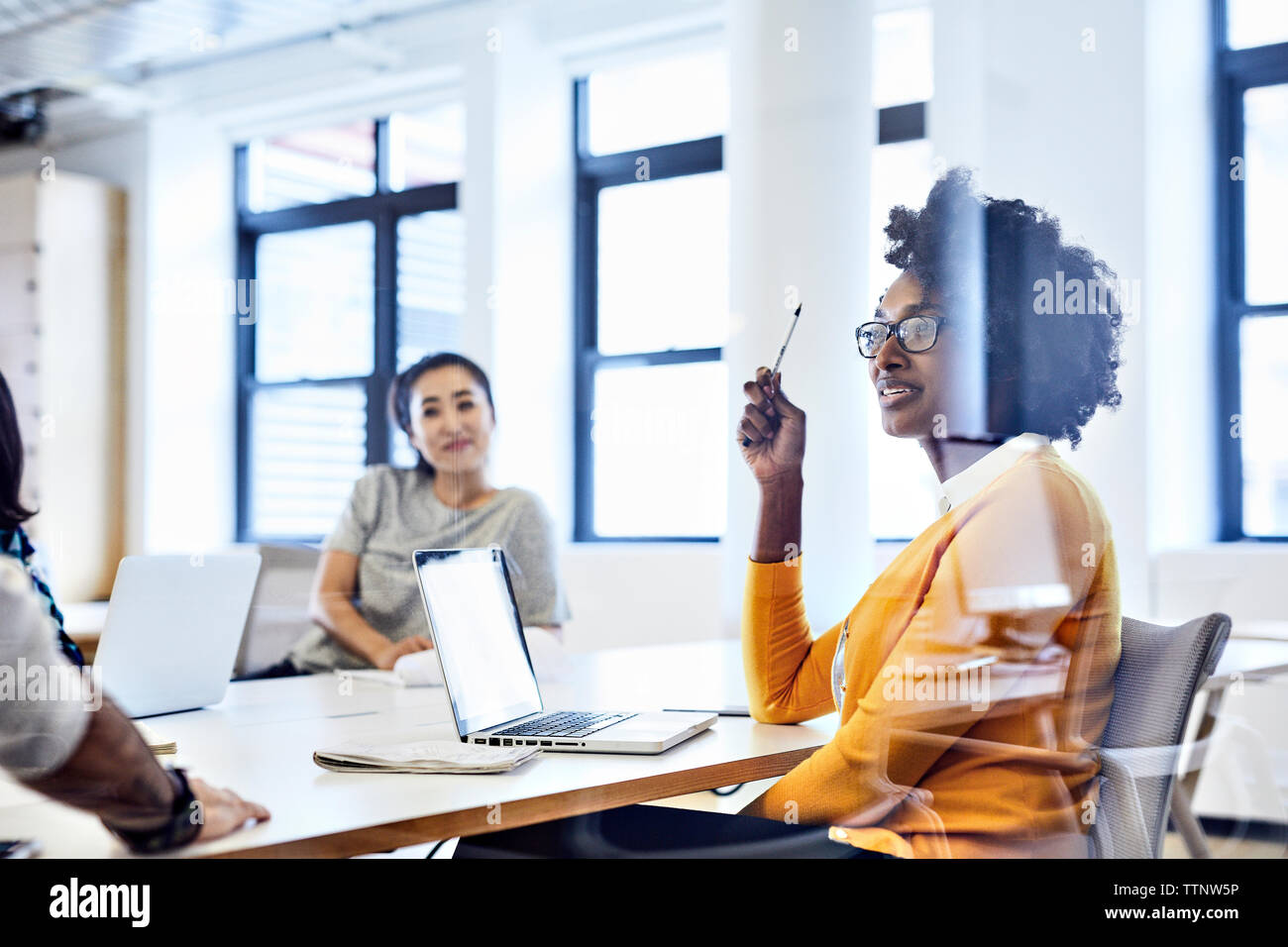 business people discussing during meeting seen through window Stock Photo