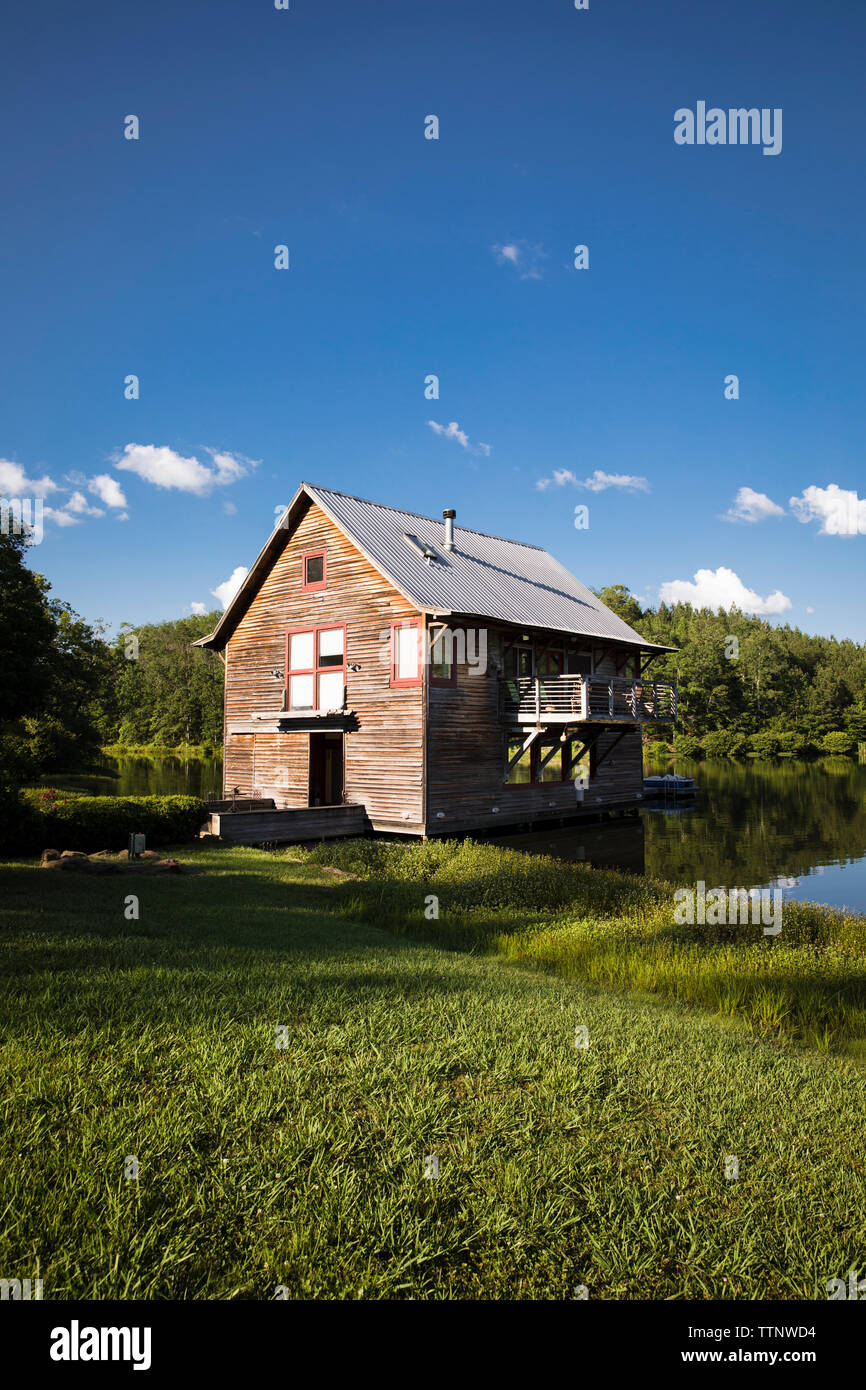 Log Cabin At Lakeshore Against Sky Stock Photo 256177856 Alamy