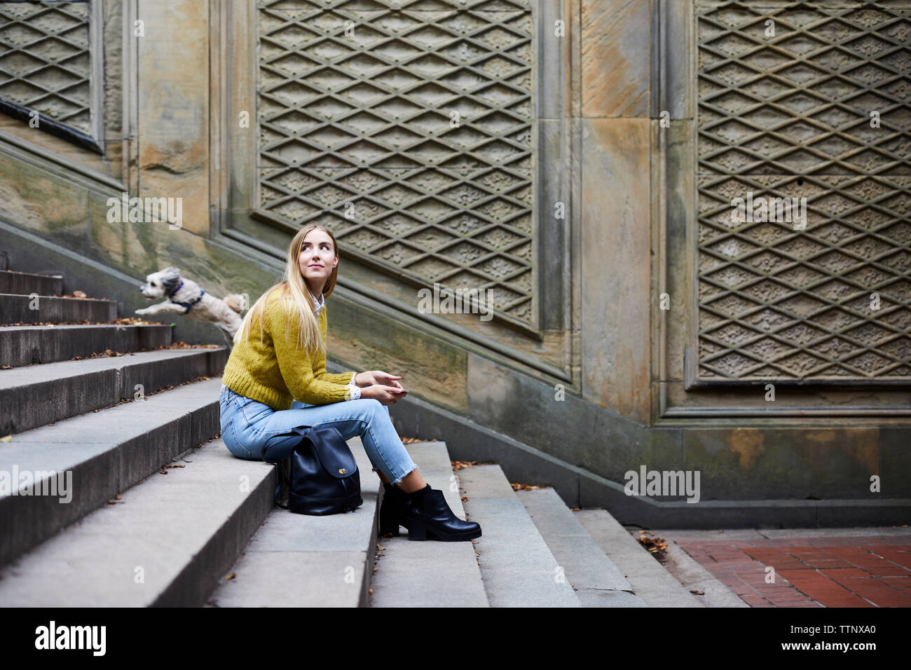 Woman sitting on steps side hi-res stock photography and images - Alamy