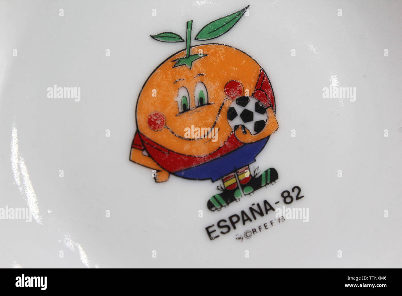 Vintage porcelain plate with logo Naranjito mascot of Soccer-football - World Cup Spain 1982, isolated on white background, close-up Stock Photo