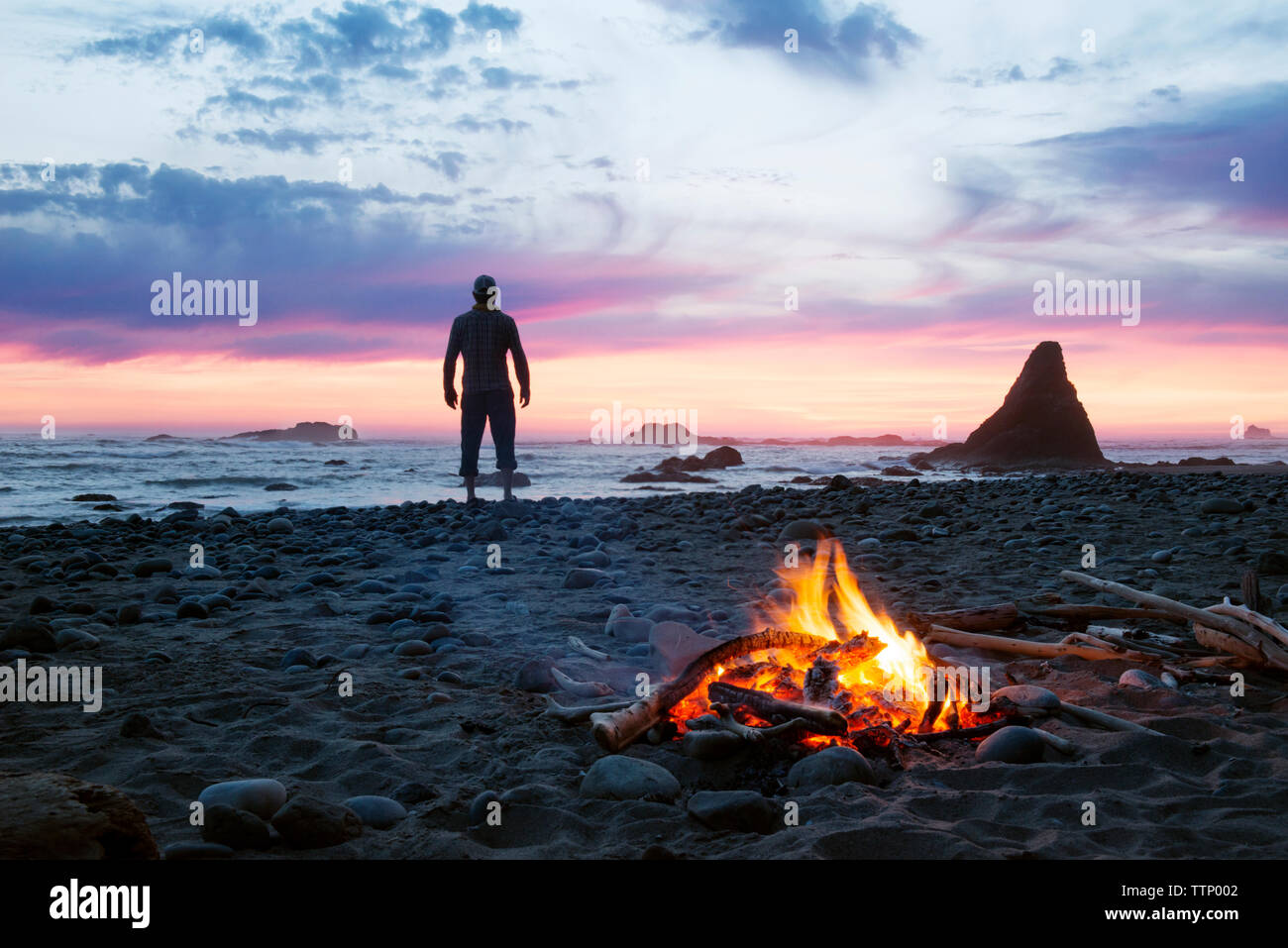 Silhouette man standing at beach during sunset Stock Photo - Alamy