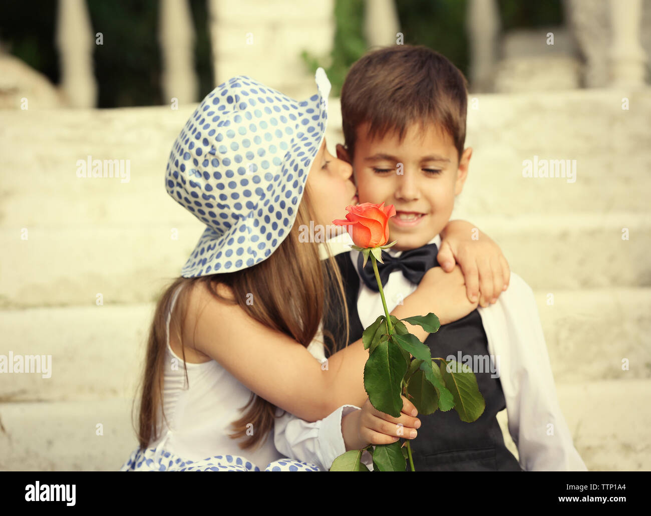 Small romantic kids on stairs Stock Photo