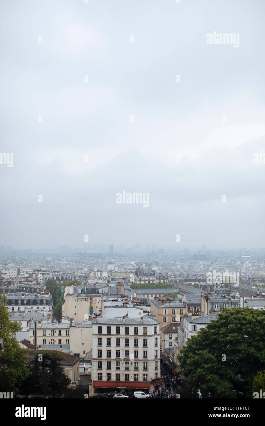 Aerial view of cityscape against cloudy sky during foggy weather Stock ...