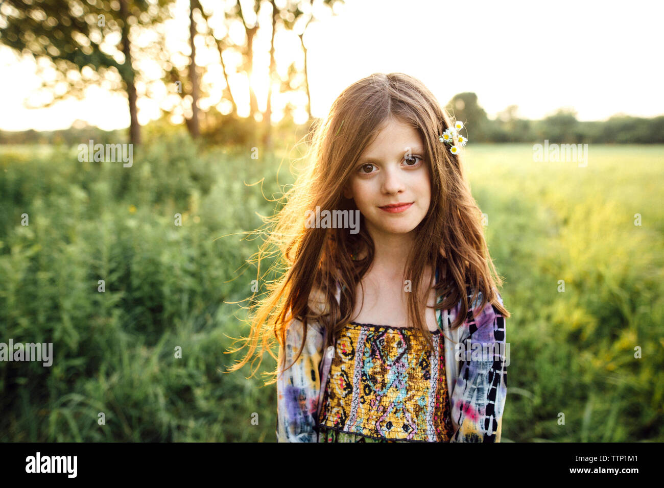 Portrait of girl standing on grassy field Stock Photo - Alamy