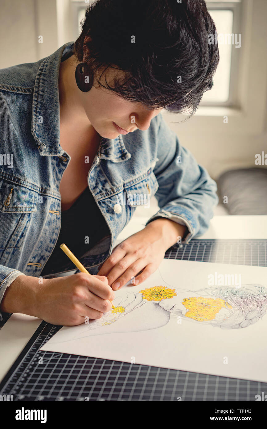 Young female artist drawing on paper Stock Photo