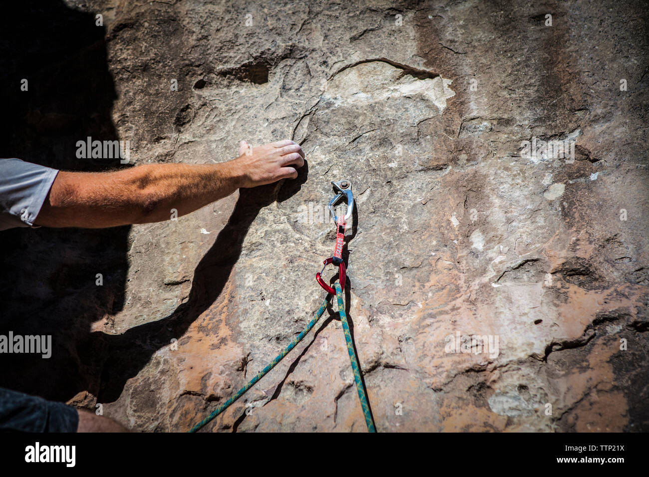 Cropped image of hand gripping while rock climbing Stock Photo