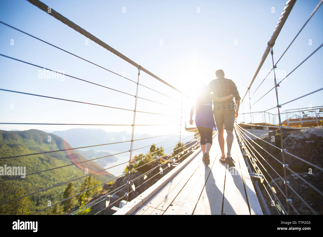 Back view couple walking arms hi-res stock photography and images - Alamy