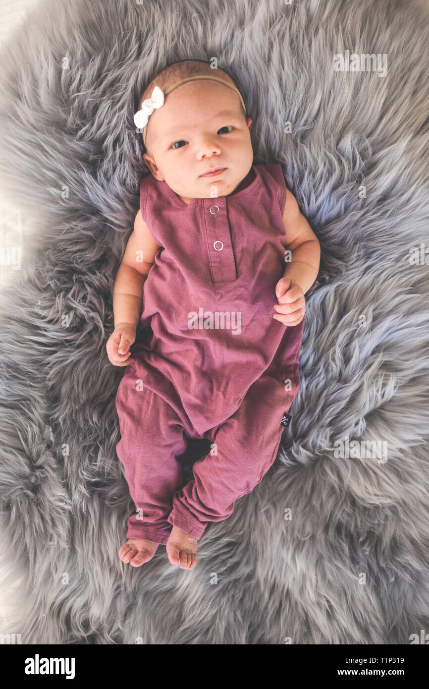 Portrait of baby girl lying on bed hi-res stock photography and images ...