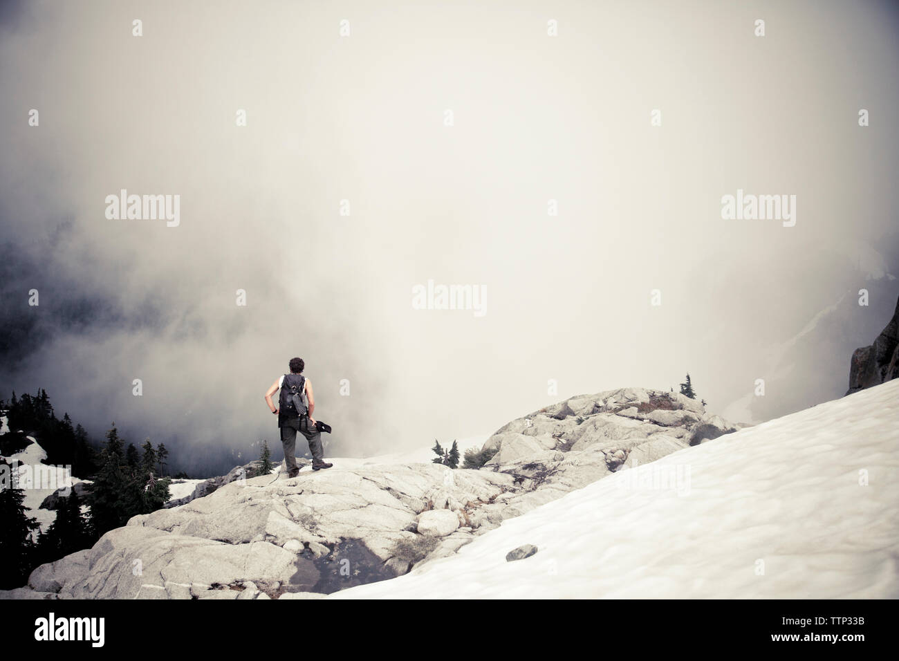 Man standing on mountain foggy hi-res stock photography and images - Alamy