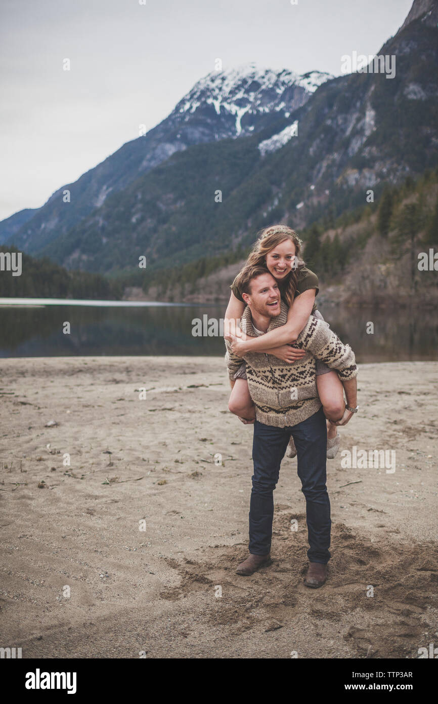 Boyfriend piggybacking girlfriend against mountains at Silver Lake Provincial Park Stock Photo