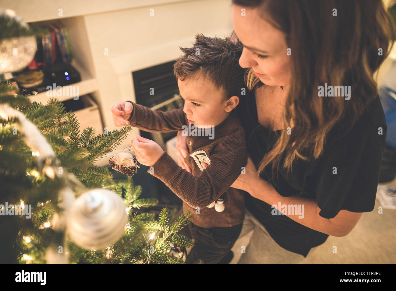 Mother and son decorate the family Christmas Tree Stock Photo