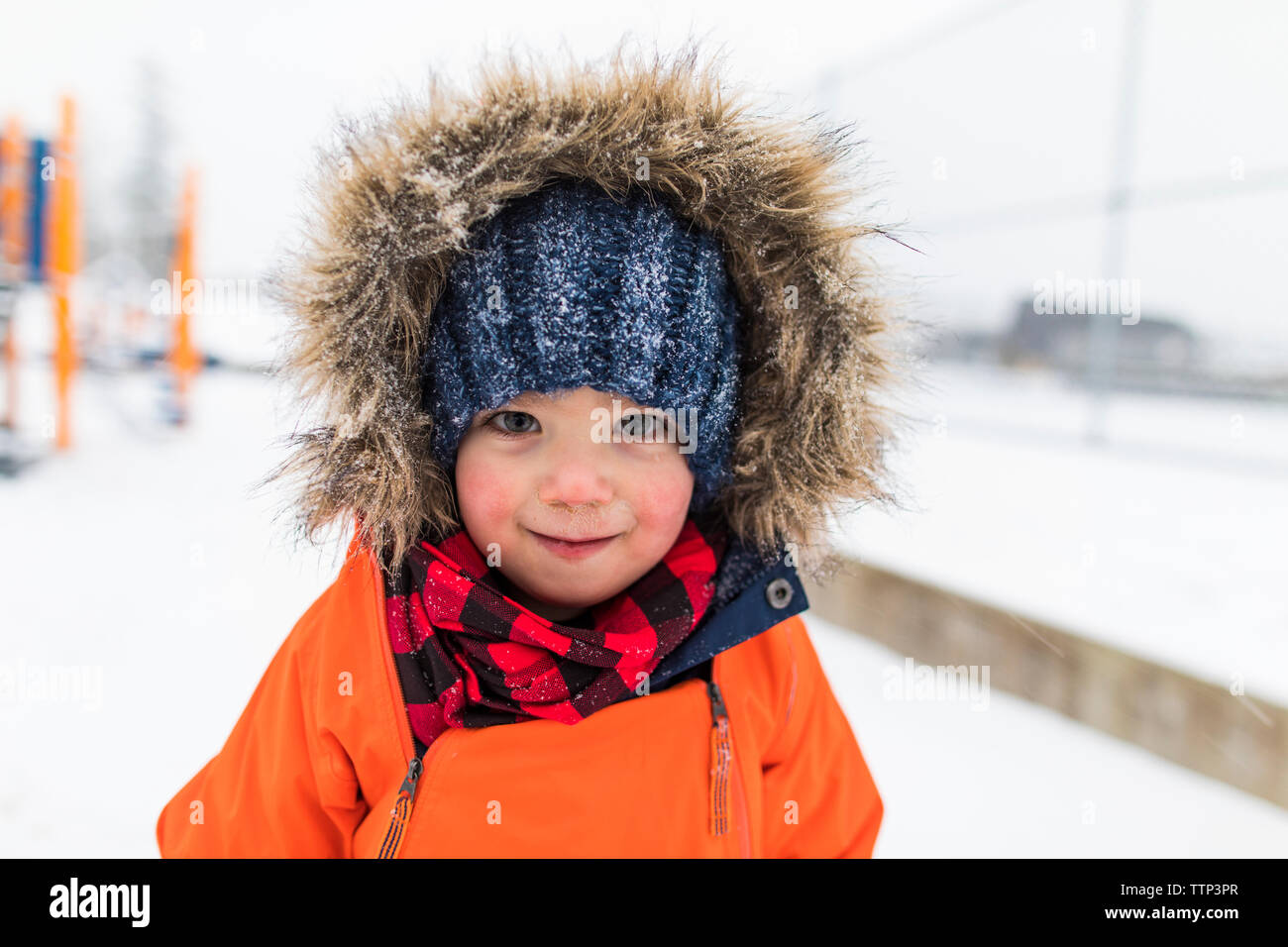 Portrait of boy in fur lined hood in winter Stock Photo