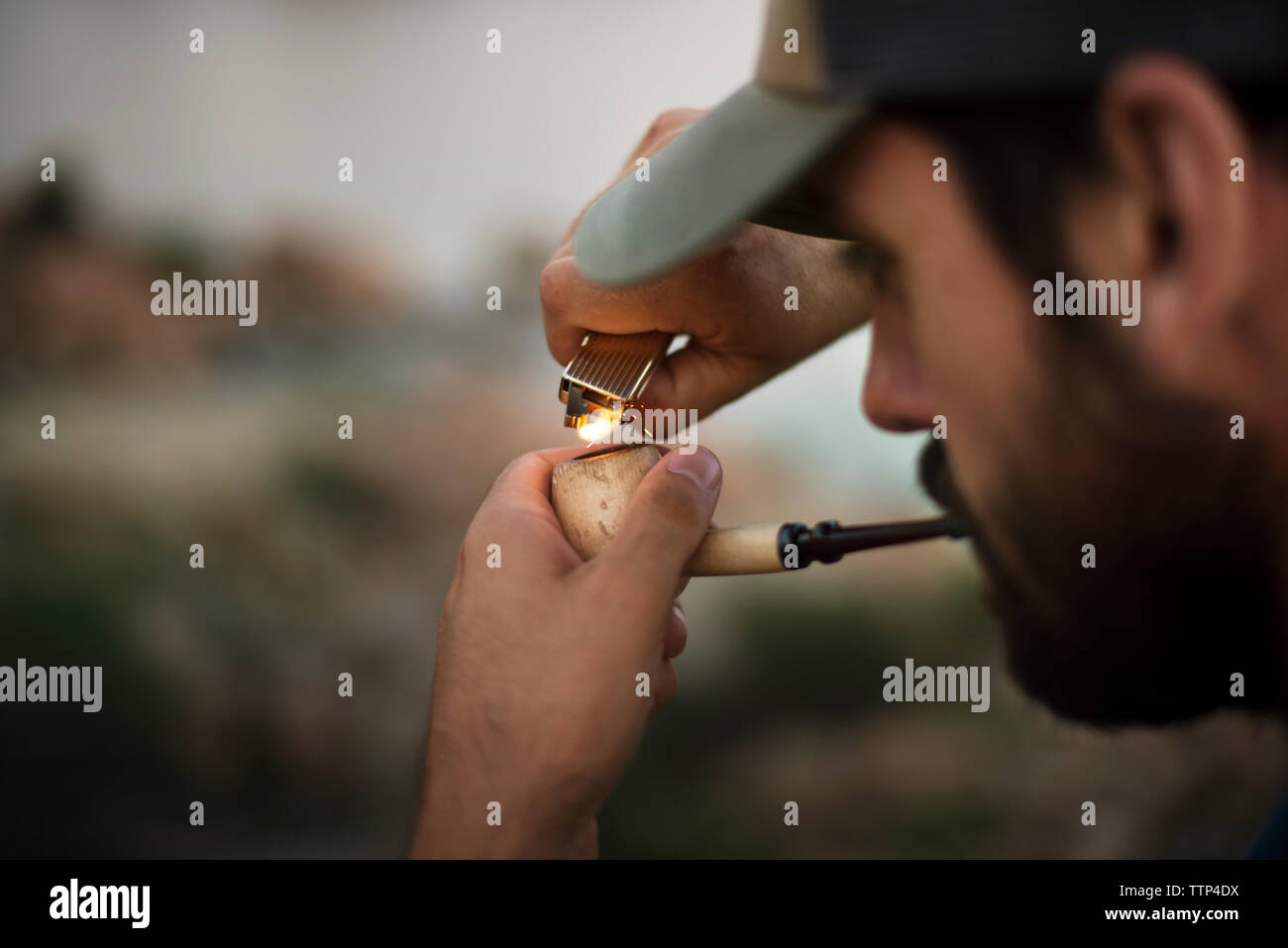 Young man lighting cigarette hires stock photography and images Alamy