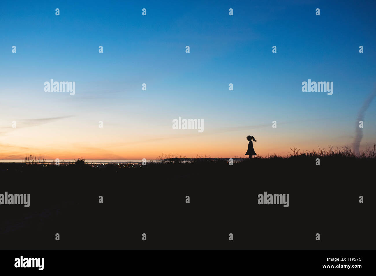 Silhouette of a young girl at sunset near San Diego Stock Photo - Alamy