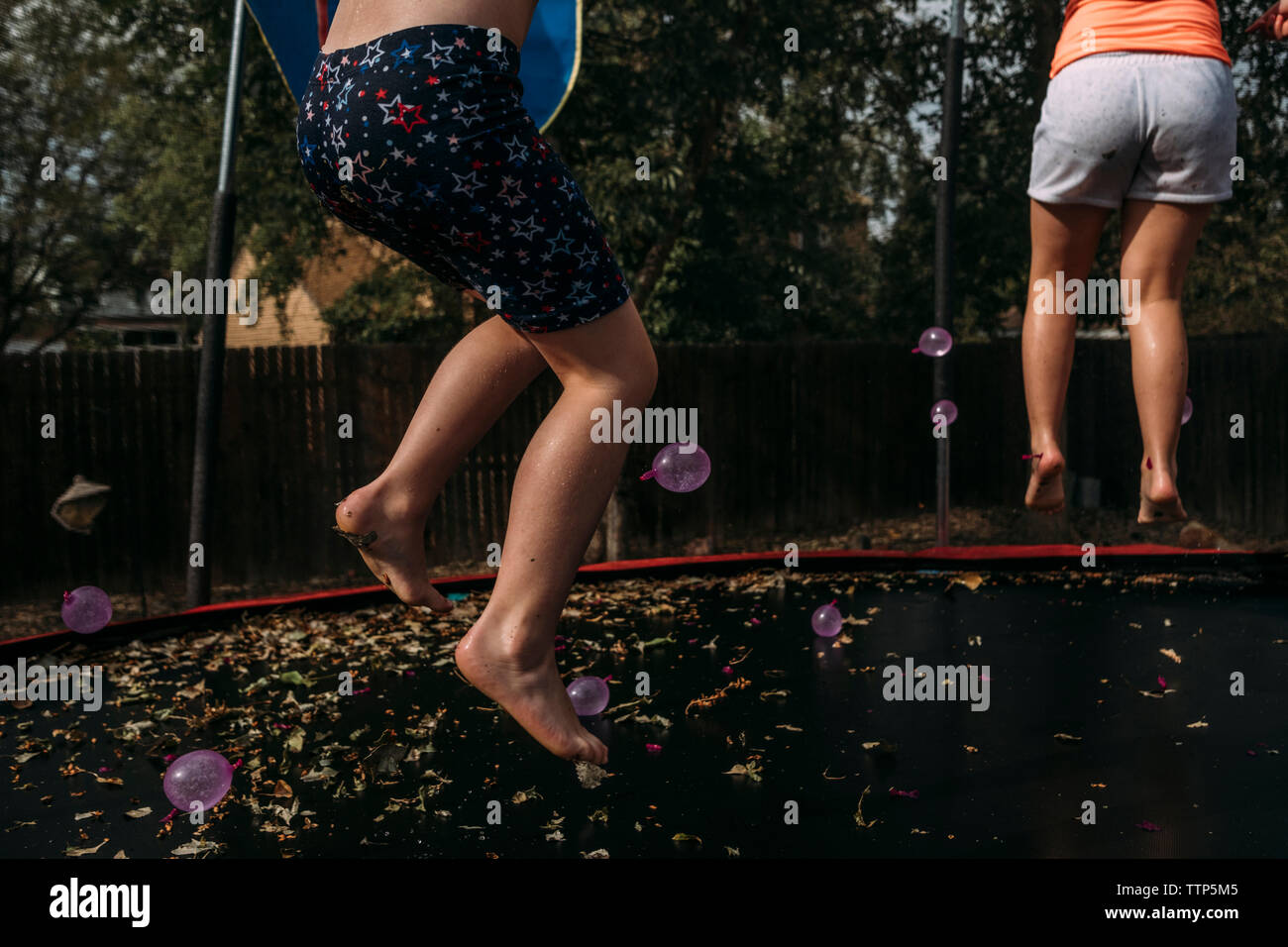 Two girls jumping on trampoline hi-res stock photography and images - Alamy