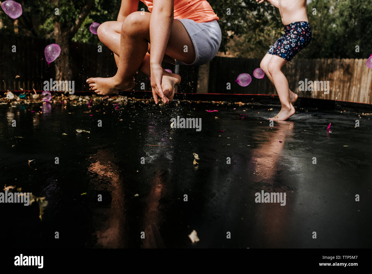 Two girls jumping on trampoline hi-res stock photography and images - Alamy