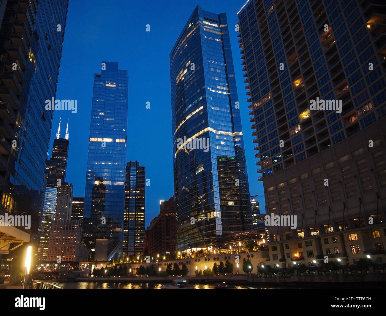 CHICAGO, IL  - JULY 28, 2018: A panoramic section of tall scenic skyline along the Chicalgo riverfront just after sunset, the blue hour. Stock Photo