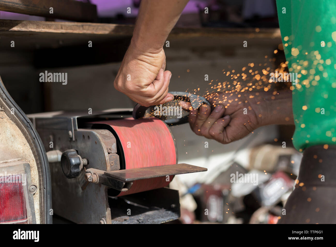Farrier grinding a horseshoe Stock Photo