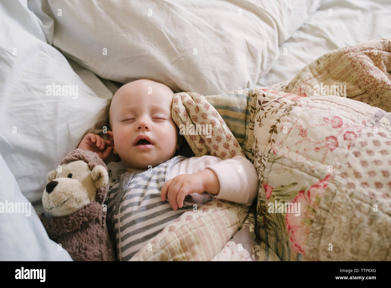 Overhead view of baby girl sleeping in bed at home Stock Photo Alamy